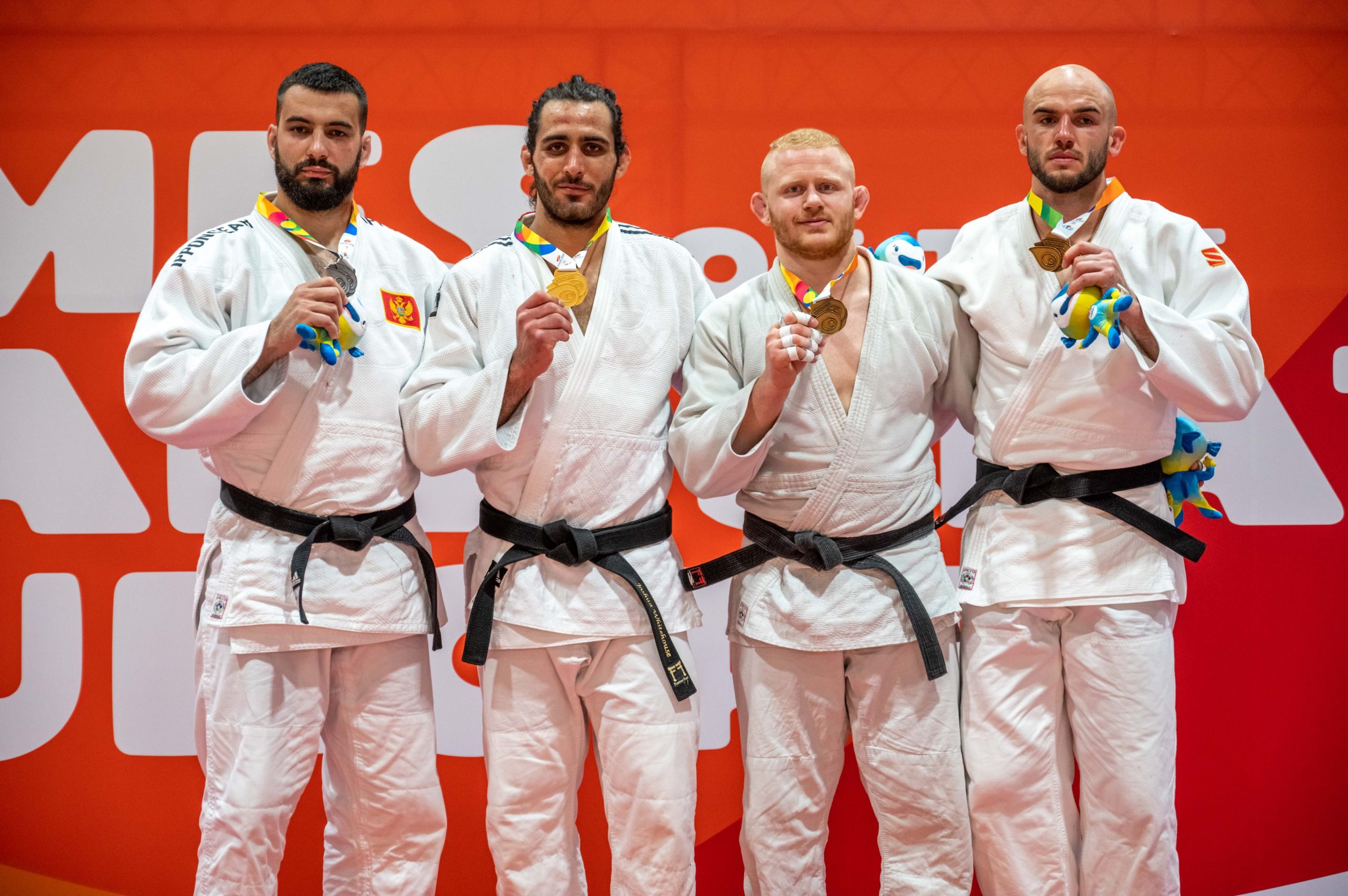 Group picture (close together). Asking the athletes to show the medals. Choose the one with all judoka with eyes open.